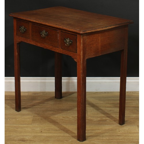 1166 - A George III oak lowboy or side table, rectangular top with moulded edge above three drawers, swing ... 