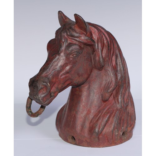 1076 - A cast iron equestrian hearth ornament, as a horses head, 26.5cm high