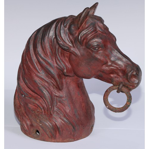 1076 - A cast iron equestrian hearth ornament, as a horses head, 26.5cm high