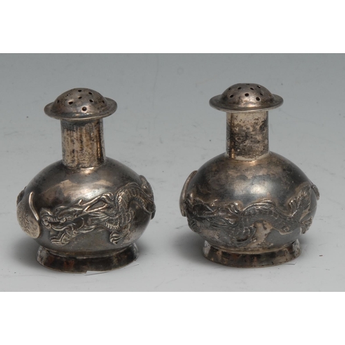 172 - A pair of Chinese silver peppers, chased with dragons, 5cm high, Kwan Wo, Canton c.1900