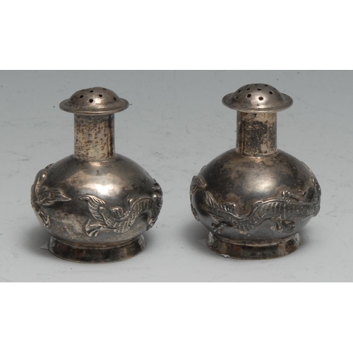 172 - A pair of Chinese silver peppers, chased with dragons, 5cm high, Kwan Wo, Canton c.1900