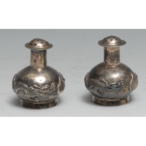 172 - A pair of Chinese silver peppers, chased with dragons, 5cm high, Kwan Wo, Canton c.1900