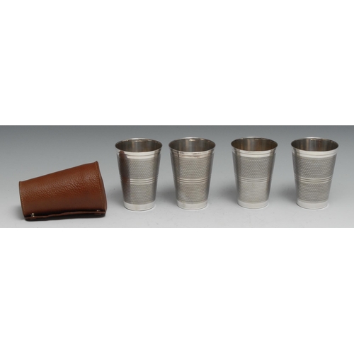 209 - A set of four Continental silver stacking travelling beakers, engine turned, 11cm high, 490g, cased