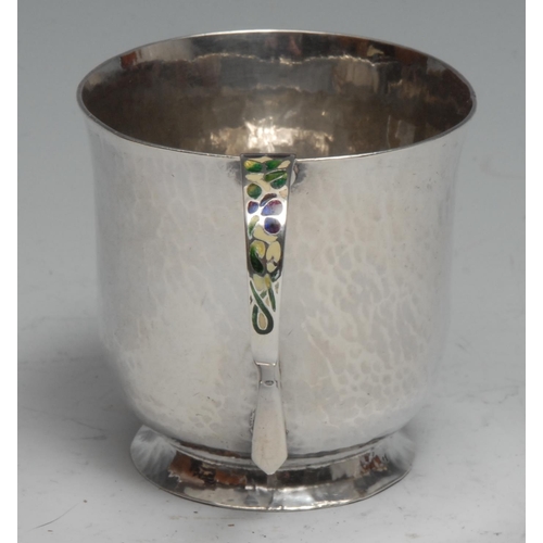 293 - Bernard Instone - an Arts and Crafts silver and enamel mug, planished overall, the scroll handle dec... 