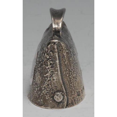 277 - An Edwardian silver novelty table bell, as a cow bell, faux-riveted and textured overall, 6cm high, ... 