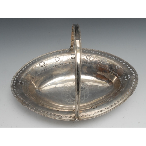 115 - A George III silver boat shaped swing handled cake basket, pierced and bright-cut engraved in the Ne... 