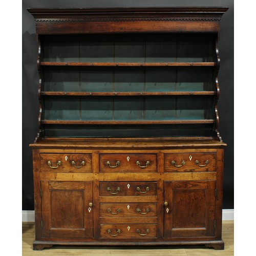 1241 - A George III oak and elm dresser, moulded cornice with dentil capital above three plate rack shelves... 