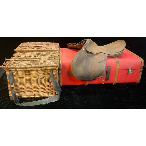 828 - A wood bound steamer trunk; a leather saddle; a wicker fishing basket; another (4)