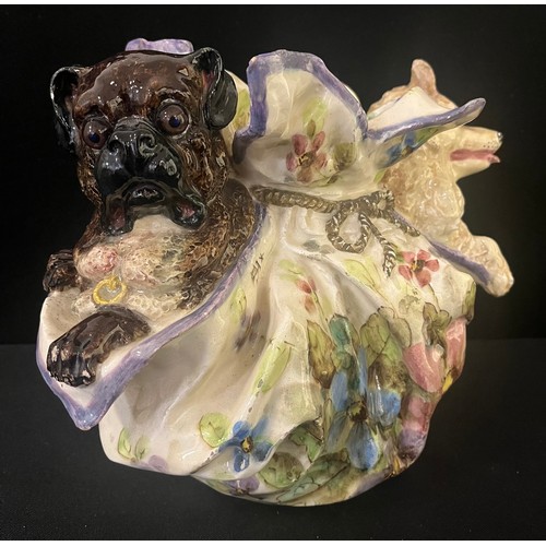 3028 - A Nove di Bassano faïence model, of a Pug and Spitz, in a lady's cloth purse, decorated with stylise... 