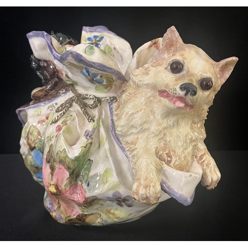 3028 - A Nove di Bassano faïence model, of a Pug and Spitz, in a lady's cloth purse, decorated with stylise... 