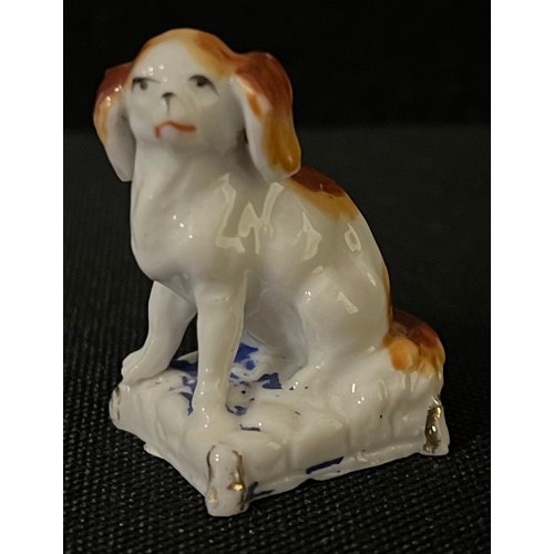 3032 - A mid 19th century Continental  Porcelain model, of a King Charles Spaniel, 4cm high, c.1850;  anoth... 