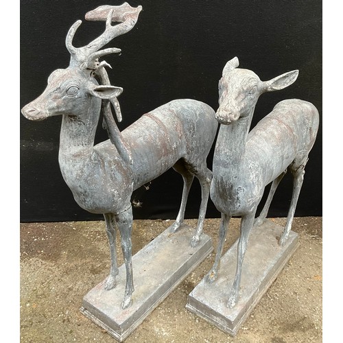 1212A - A pair lead garden statues, of a  stag and  doe, standing, rectangular bases, possibly based on the ... 