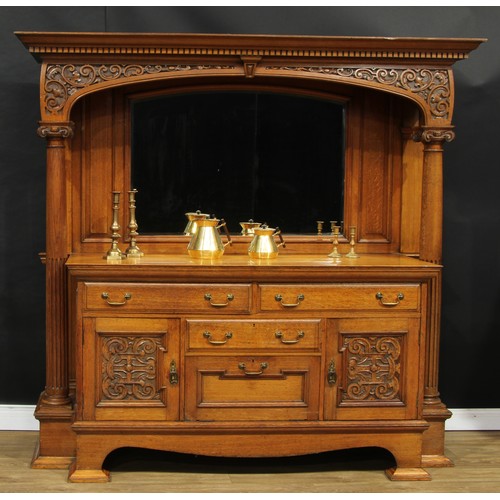 1639 - An Arts & Crafts oak sideboard, outswept cornice with dentil capital above an apron carved with leaf... 