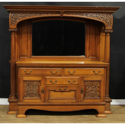 1639 - An Arts & Crafts oak sideboard, outswept cornice with dentil capital above an apron carved with leaf... 