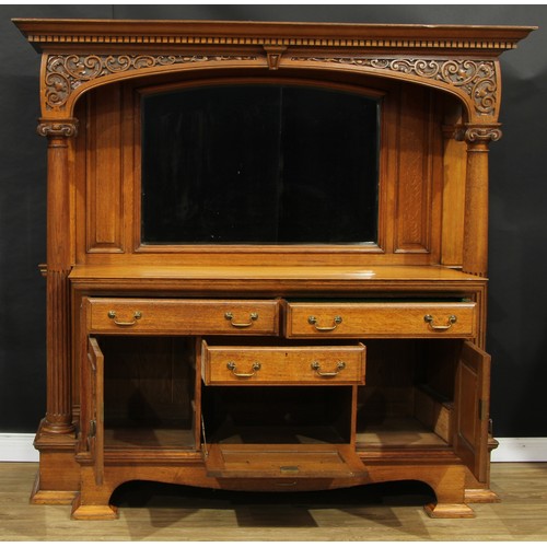 1639 - An Arts & Crafts oak sideboard, outswept cornice with dentil capital above an apron carved with leaf... 