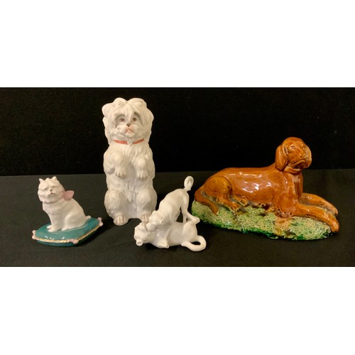 3309 - A late 19th century continental porcelain figure group, Two Pugs at play, 7cm high, unmarked;  a Gri... 