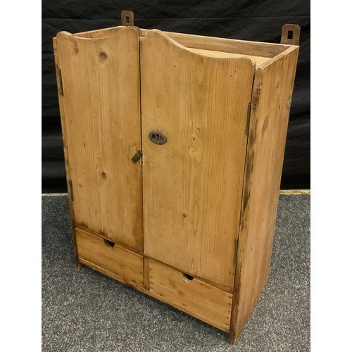 5 - A pitch pine parlour or kitchen spice cupboard, the shaped doors enclosing two shelves above a pair ... 