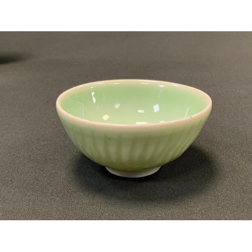 21 - A Chinese Celadon circular tea bowl, impressed decoration, 8.5cm diameter; an eighteenth century ear... 