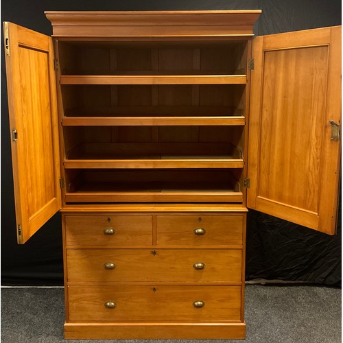 31 - A Victorian pine Linen Press, having moulded cornice with pair of panelled cupboard doors to top enc... 