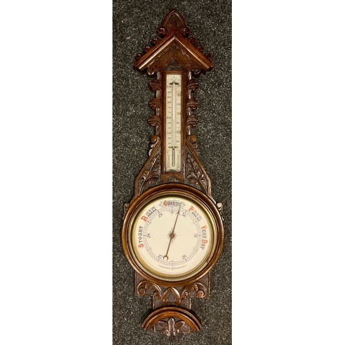 58 - A carved oak barometer thermometer, floral carved case, cream aneroid scale, 89cm long