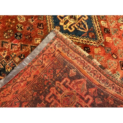 164 - A South-west Persian Qashgai wool rug / carpet, hand-knotted with three diamond shaped medallions wi... 