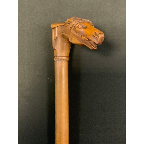 172 - A Victorian walking stick, the handle carved with horses head and saddle, 89cm long, c.1890