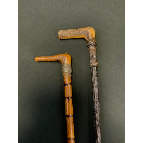 200 - An early 20th century riding crop, horn haft, bamboo shaft, 67cm long;  another (2)