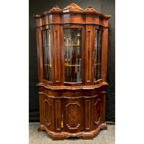 185 - A reproduction walnut and mahogany serpentine front vitrine display cabinet, 209cm high x 128cm wide... 