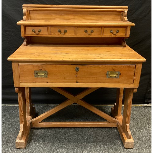 266 - A Pitch-pine desk, galleried back with open shelf and row of four small drawers, above a rounded rec... 