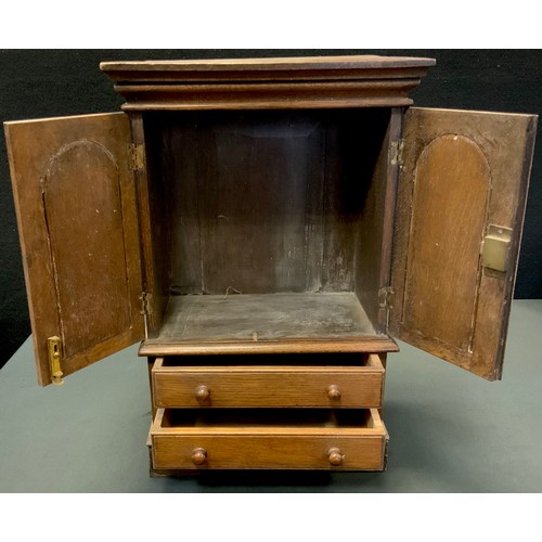 277 - Miniature Furniture - a  George IV oak cabinet, moulded cornice above a pair of arched panelled door... 