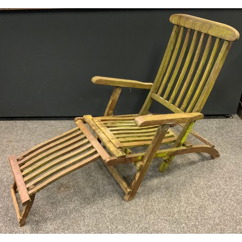 293 - A folding  recliner steamer garden chair, built in foot stool;  pair of 1960s/1970s canvas deck chai... 