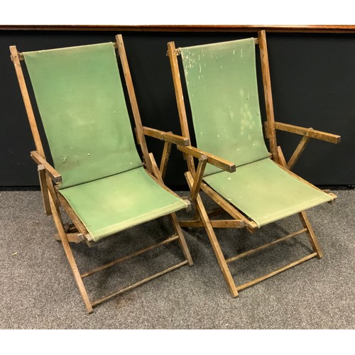 293 - A folding  recliner steamer garden chair, built in foot stool;  pair of 1960s/1970s canvas deck chai... 