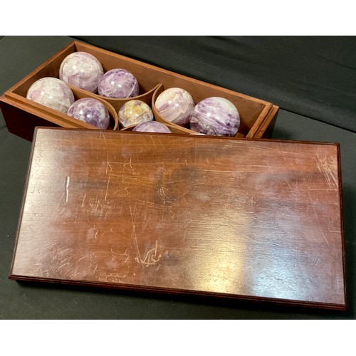 336 - A set of Nine Amethyst and hard stone balls, various sizes, in mahogany case