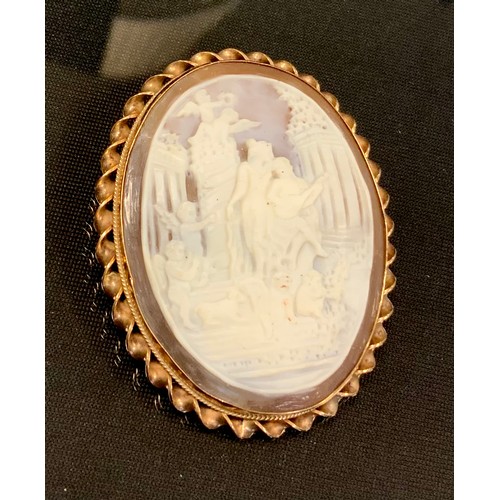 439 - An oval cameo brooch, allegorical scene with Eros, Cherubs, minstrels etc, 9ct gold mount, 5.5cm x 4... 