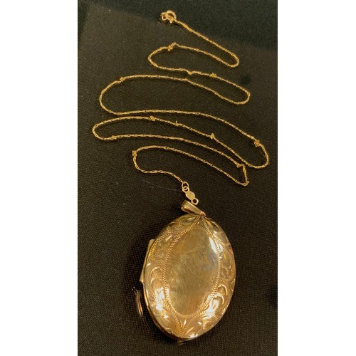 440 - A 9ct gold oval locket, 7.6g gross;  fine link necklace stamped 585 14k, 0.8g