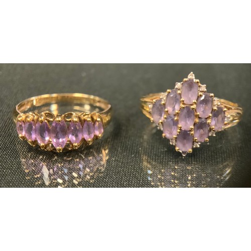 467 - A 9ct gold navette cluster ring, set with nine pale purple oval stones, twelve diamond accents, 9ct ... 