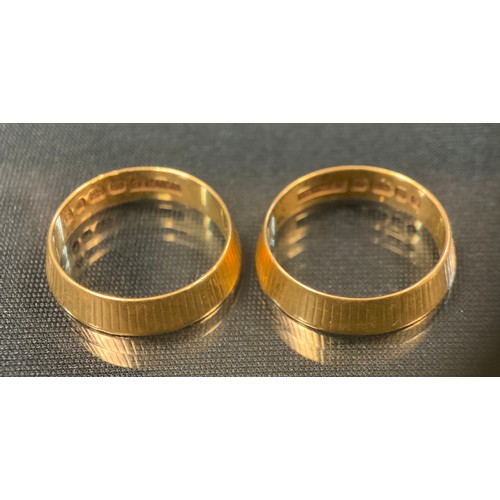 482 - A pair of 22ct gold textured tapering wedding bands, size N, W W Ld, London 2004. 8.7g gross (2)