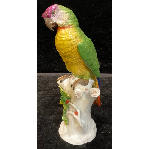 29 - A Ludwigsburg porcelain model of a parrot, naturalistically modelled perched on a branch, 30cm, crow... 