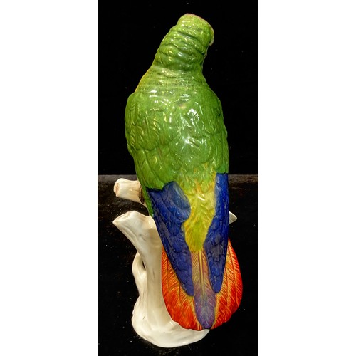 29 - A Ludwigsburg porcelain model of a parrot, naturalistically modelled perched on a branch, 30cm, crow... 