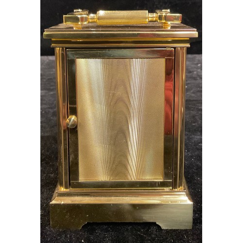 96 - A Taylor & Bligh brass carriage timepiece, quartz movement, 17cm high over swing handle