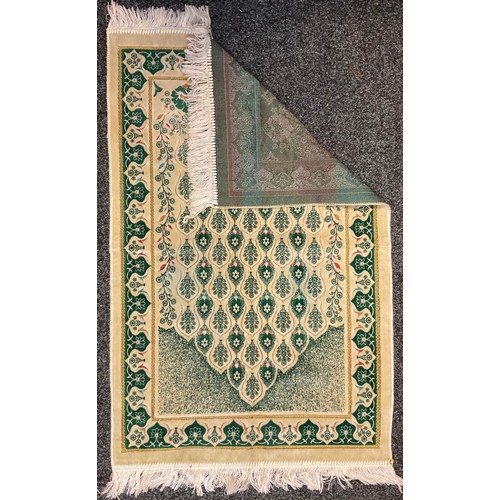 227 - An Islamic woollen prayer mat, Turkey, stylised green floral design on cream ground with gilt thread... 