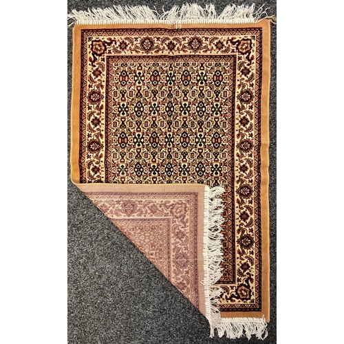 234 - A Islamic woollen prayer mat, Saudi Arabia, geometric pattern in shades of red, green, black and och... 