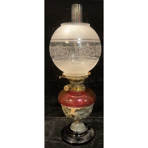 453 - A late 19th century oil lamp, Cranberry glass font, later converted to electricity