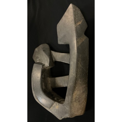 6 - Tribal Art - a carved hardstone abstract figure, polished and textured finish, 65cm high