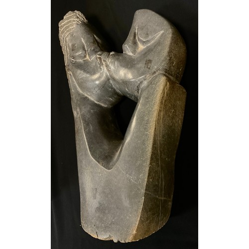 11 - Tribal Art - A carved hardstone figure, the kiss, polished and textured finish, 58cm high