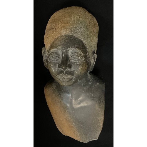 13 - Tribal Art - a carved hardstone bust of an elder, her hair in a head wrap, polished and textured fin... 