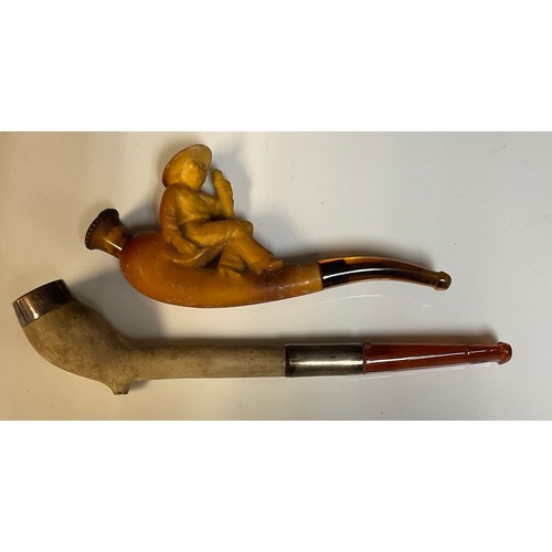 677 - A 19th century Meerschaum sailor cheroot pipe; a silver mounted clay pipe; both cased (2)