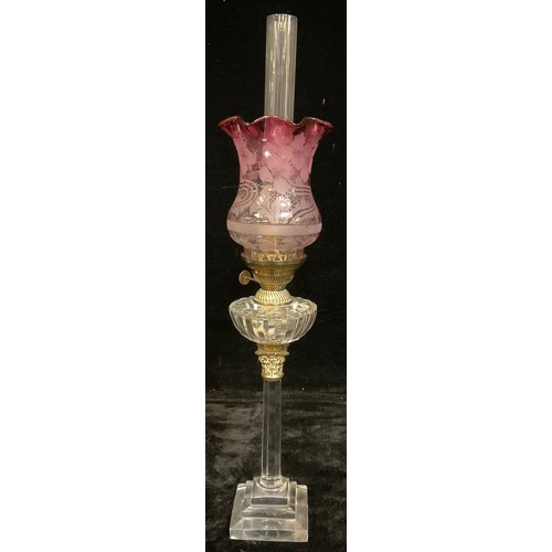 793 - A late 19th century oil lamp, clear glass columnar stem, stepped square base, brass Corinthian capit... 