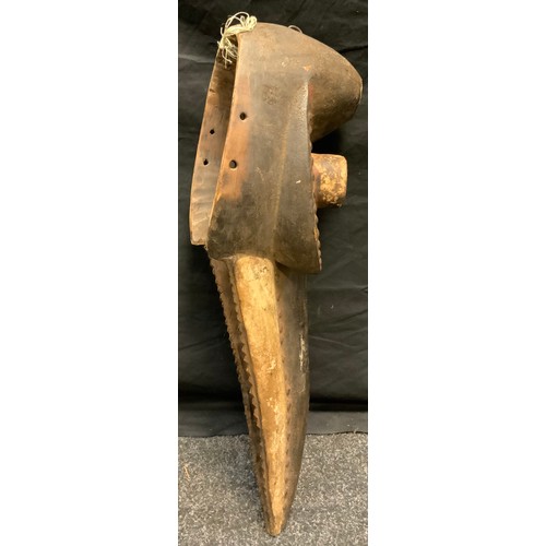 34 - An African tribal zoomorphic dan bird mask, hole eyelets, elongated beak, nailed details, picked out... 