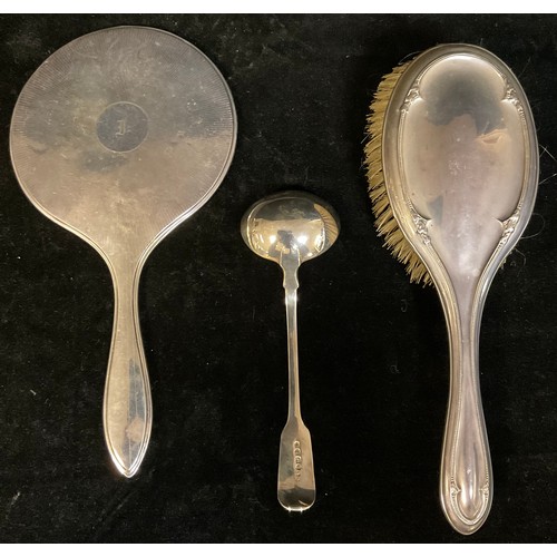 861 - A William IV silver sauce ladle, London 1832, 50g; a George V silver hand mirror, engine turned, Bir... 